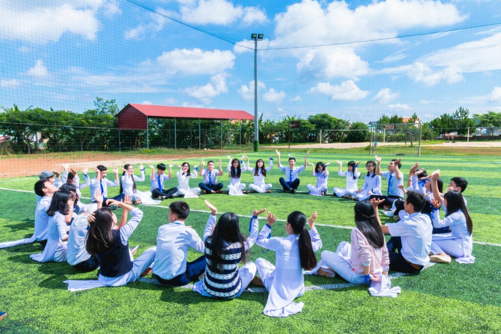 Students seated in a circle on a school facility that requires chemical solutions.